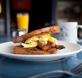2 eggs your way, sausage and bacon, crammed between 2 pieces of french toast, & served w/ hash browns