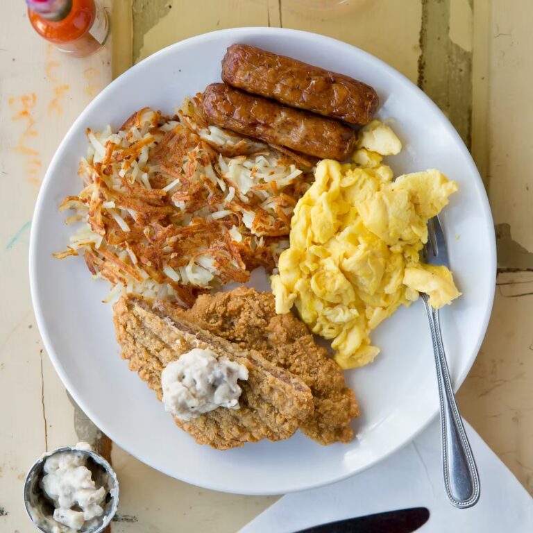 Country fried steak with crispy hashbrowns, sausage links and scrambled eggs