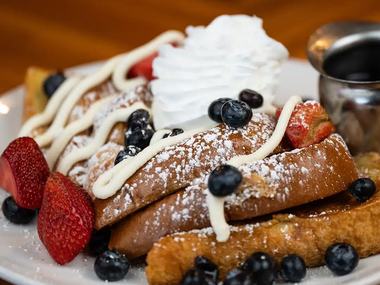 French toast with strawberries, blueberries and powdered sugar.